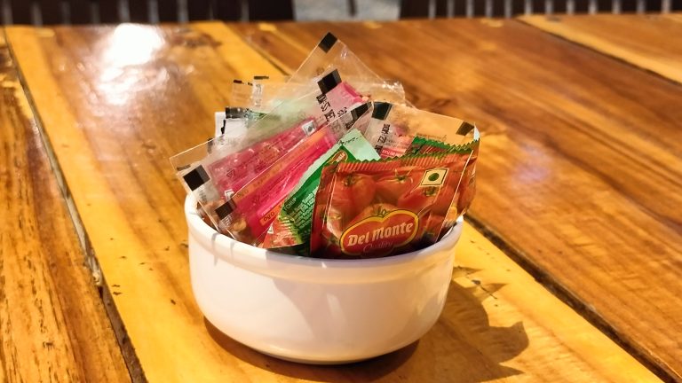 A bowl filled with ketchup, red pepper flakes, and pizza spices, ready to enhance your favorite dishes.