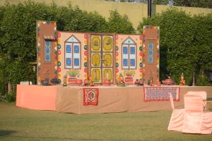 Outdoor stage with colourful hand-made decorations in a garden
