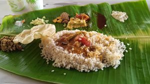 Closeup photo of Marriage "Sadhya", traditional rice dish served in a palm leaf.