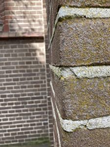 A brick wall with different style bricks