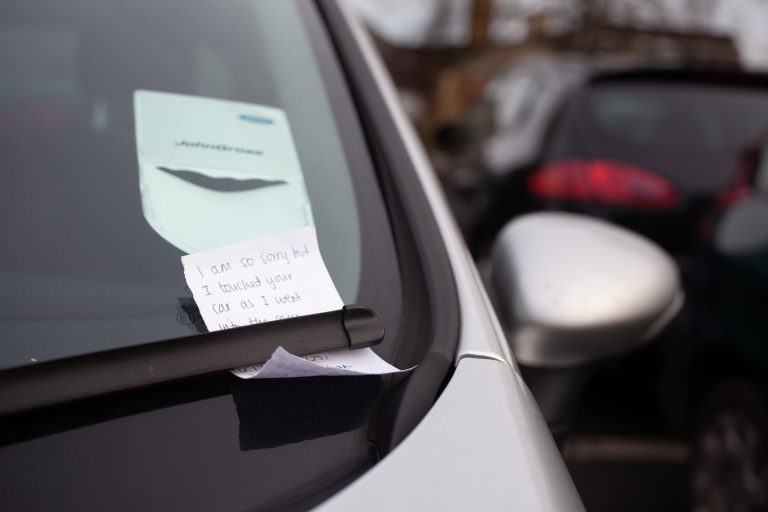 Note on a car window, under a window washer