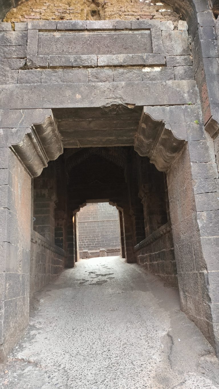 Close look of 3 door (tin darwaza) from outside, Panhalgad near Kolhapur India
Message written by Mughal Empire in Urdu is visible above door.