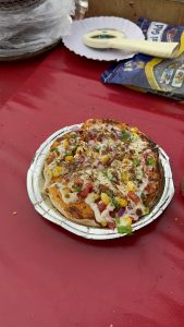 A small vegetarian pizza in a street food market India.
