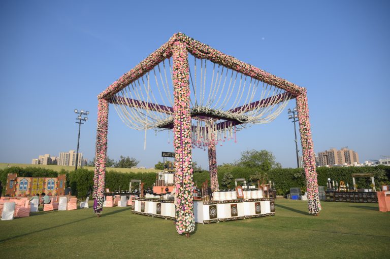 Colorful handmade decorations for an outdoor wedding in a garden