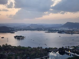 Hill top view of Udaipur city lake and mountain range.