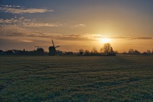 Sunrise with a windmill in the front