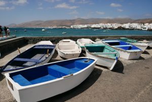 White and blue boats in a platform above the sea in Lanzarote island