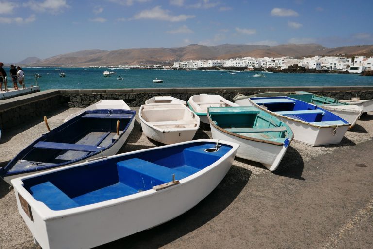 White and blue boats in a platform above the sea in Lanzarote island