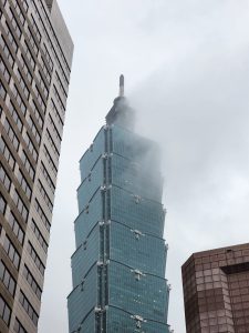 Taipei 101 building covered with fog.
