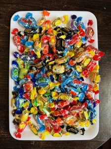 Different colors of candy in a tray. 