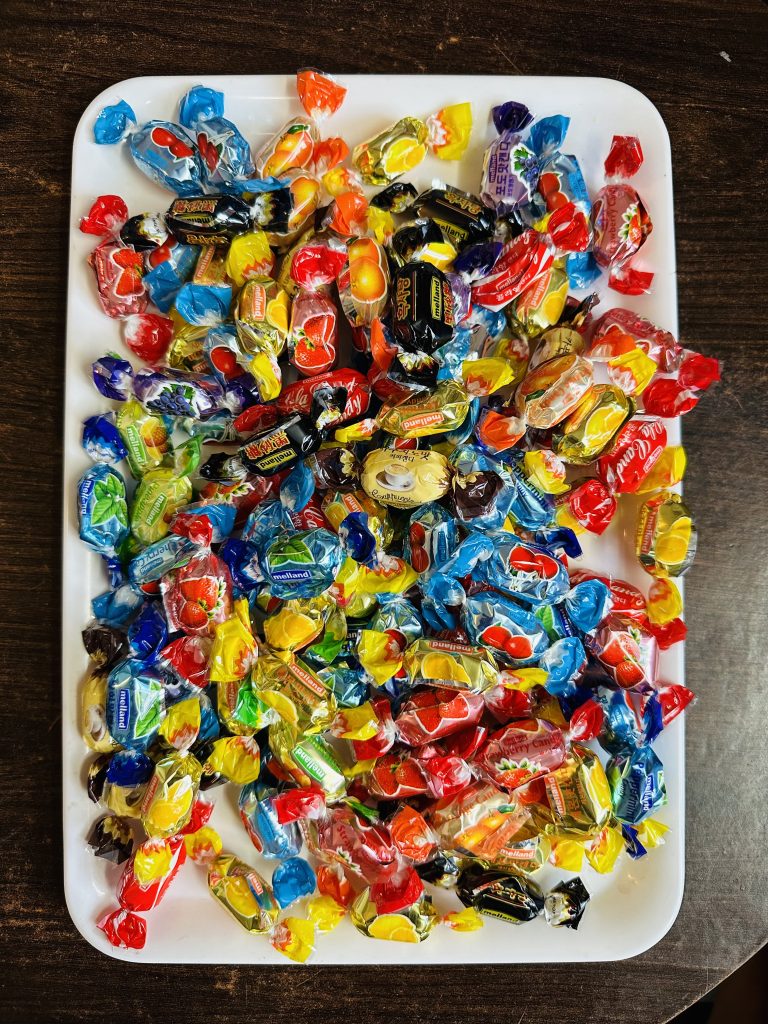 Different colors of candy in a tray.