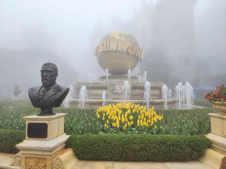 Wonder world town square at the top of Ba Na Hills with fountain and a statue.