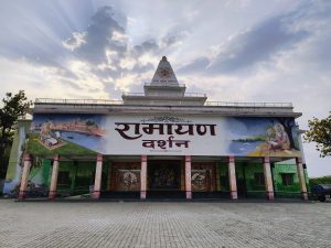 Vivid mural on building depicts hindu mythology. Sky with sunlight adds serenity.