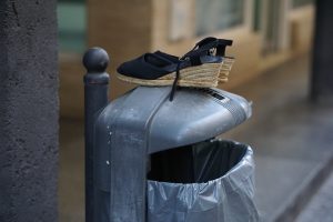 Pair of black espartos (traditional flamenca shoes) left on top of a garbage bin by someone who had enough Feria de Abril this year