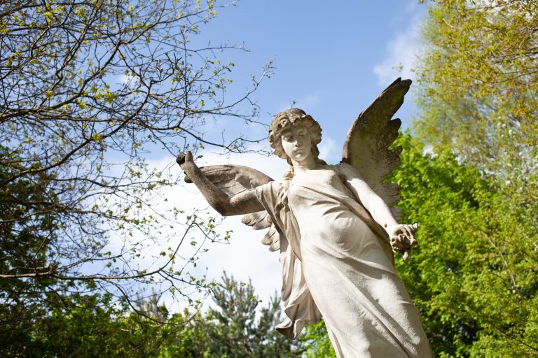 Angel statue with trees in the background