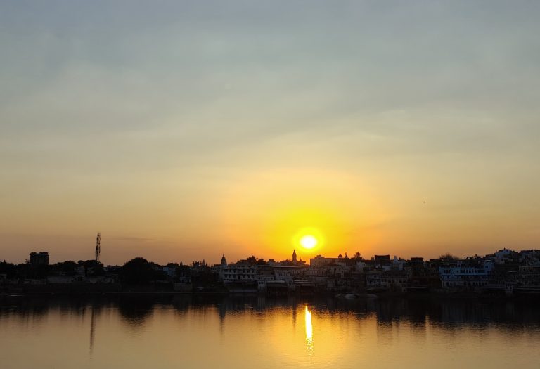 Scenic evening view with sunlight reflecting on the water.