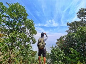 View larger photo: A hiker observing the view from a high point along the hiking route.