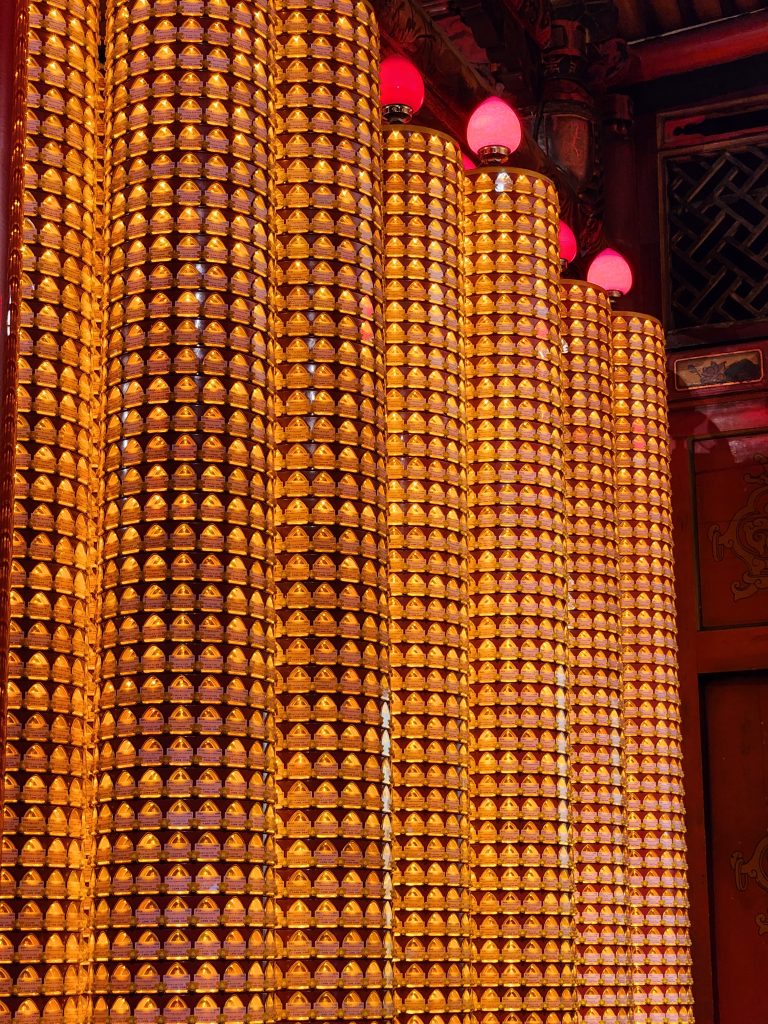 Pillars with string of lamps in the temple at Taipei.