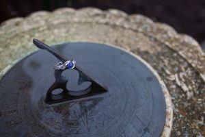 Engagement ring on a sundial in the rain