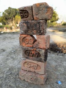 a stack of bricks with numbers carved into them.