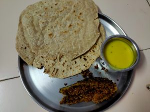 An Indian Dish of Bitter gourd, Jowar bhakri (Bread) and yogurt soup (Kadhi)