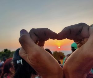 View larger photo: Capturing Love: Sunset Framed in Heart-Shaped Hands