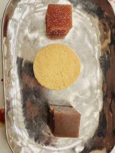 Three pieces of dessert on a tray.