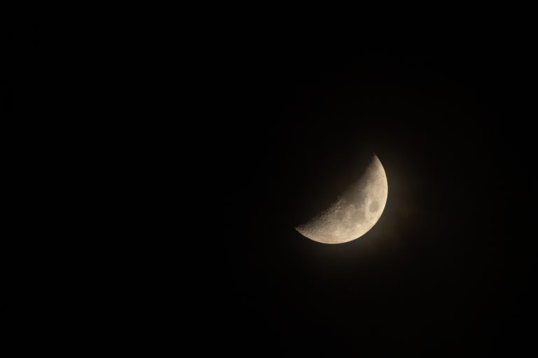 Crescent moon behind foggy cloud, as seen from the Netherlands