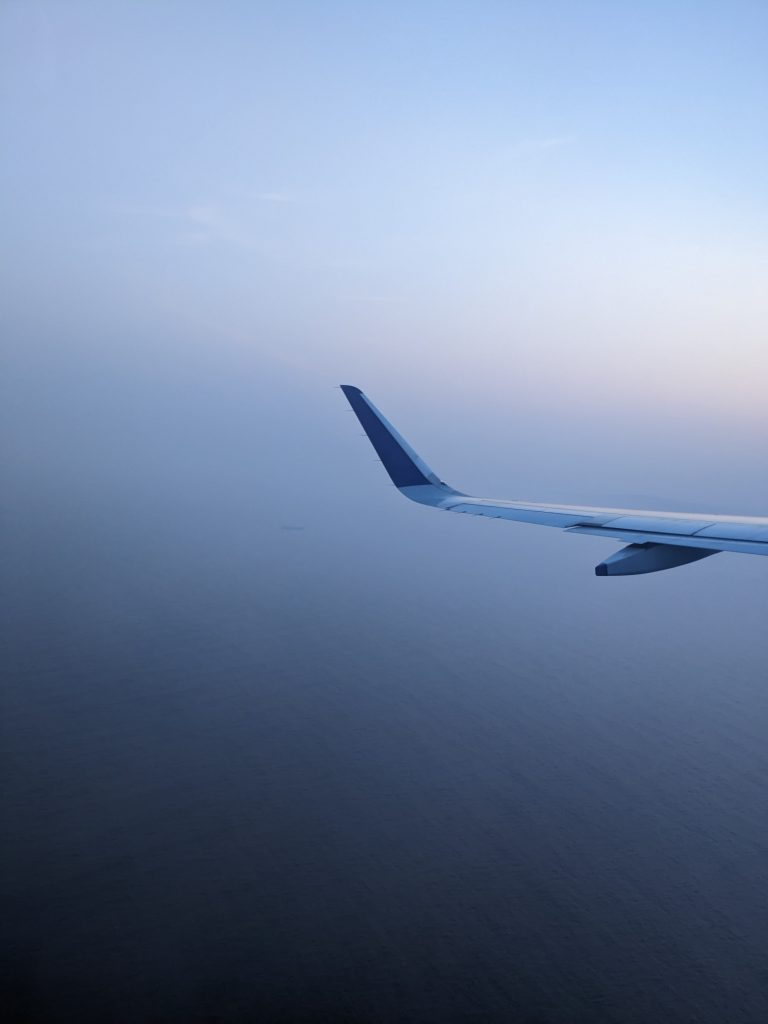 Blue sky and a view of the blue sea from the aeroplane.