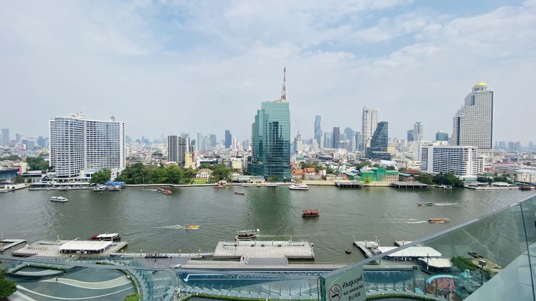 High-rise building by the riverside with a scenic view of the water and city skyline