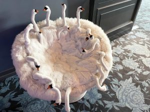 A round chair of a hotel designed as a group of swans. From Munich, Germany. 