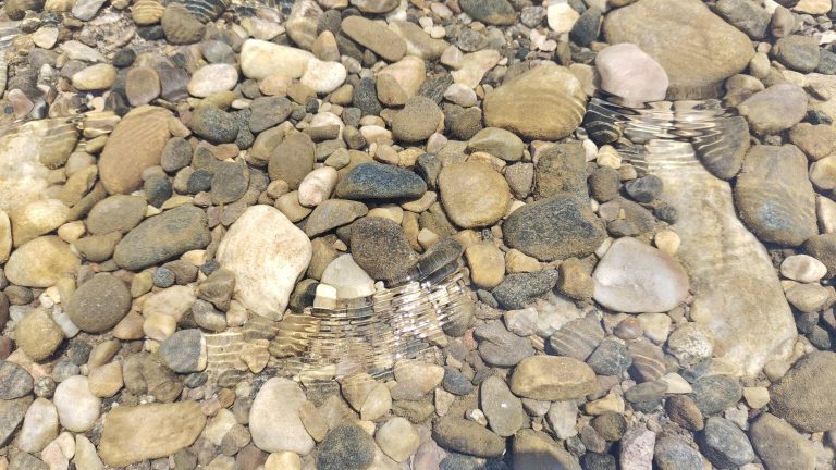 Rocks under the clear water in Sada Pathor, Sylhet.