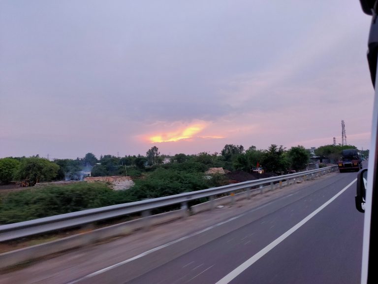 Golden Glow: Sunset Light Behind Clouds Turning the Sky a Brilliant Orange