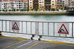 Board a ferry with signs warning you of the danger of jumping into the water with your car