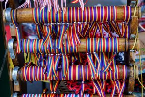 Colorful wristbands, some with the pride flag and others with the Spanish Republic flag.