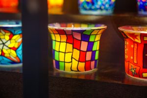 Stained glass candle pot with the colors of the rainbow.