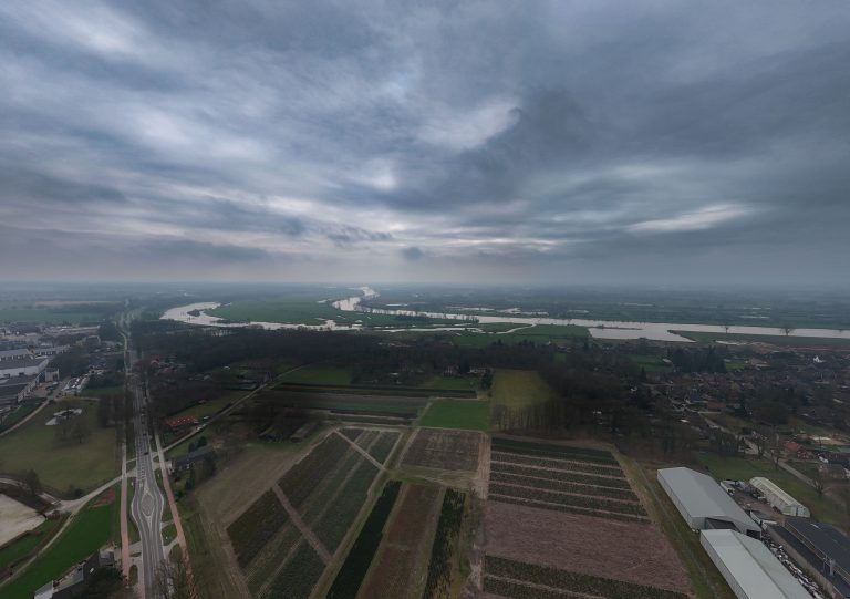 Aerial photo with a cloudy sky of the Niers and Meuse rivers seen from the village of Milsbeek, the Netherlands.