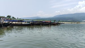 Several boats parked at a dock on a sunny day.