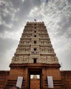 Entrance tower (gopuram) of the Ranganath Temple. This temple features a towering structure adorned with intricate carvings of deities and mythological scenes across its multiple tiers.