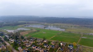 Aerial view with a cloudy sky of part of the village of “Milsbeek” and nature reserve "de Diepen” (the Deeps) and the “Sint Jansberg” (Saint Johns mountain), the Netherlands. 