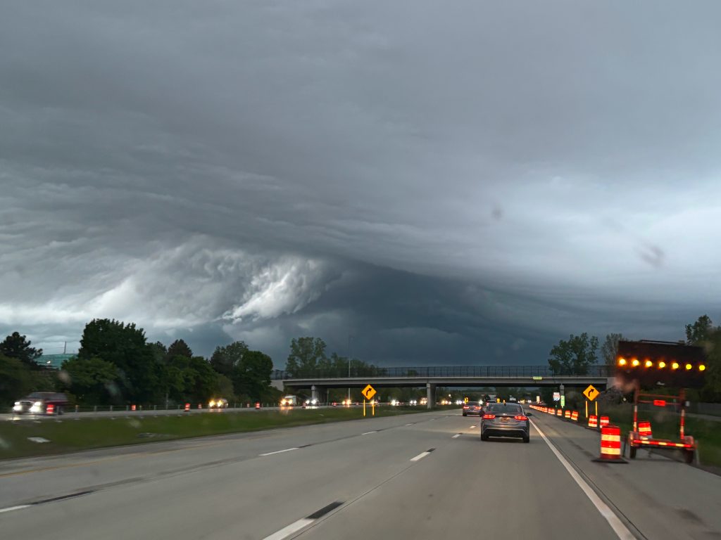 Dramatic storm cloud formation over a highway