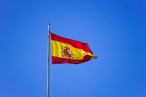 Spanish flag waving over a clear blue sky