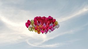 Multicolor heart shaped balloons floating in the sky