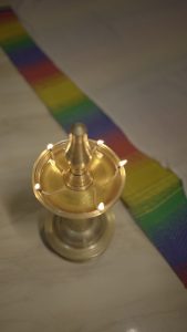 View larger photo: A brass oil lamp with multiple lit wicks