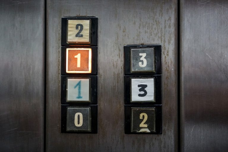 Strange button panel on a rusty elevator