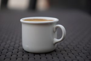 Small cup of coffee with a blurred background
