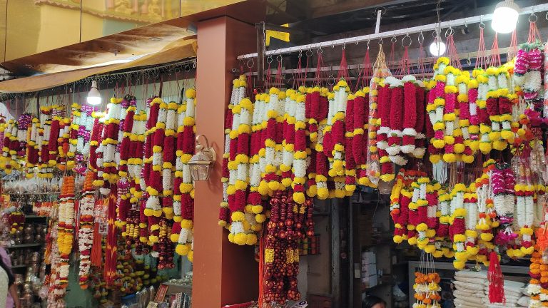 Colorful artificial garlands hanging in a marketplace