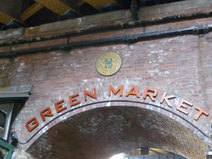 View larger photo: Brick archway with Green Market sign and within a circular badge above the arch (Chicago, Illinois)