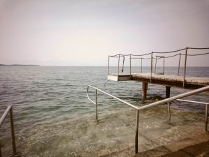 Pier over water leading from the right to the center of the photo. (in-camera filter)