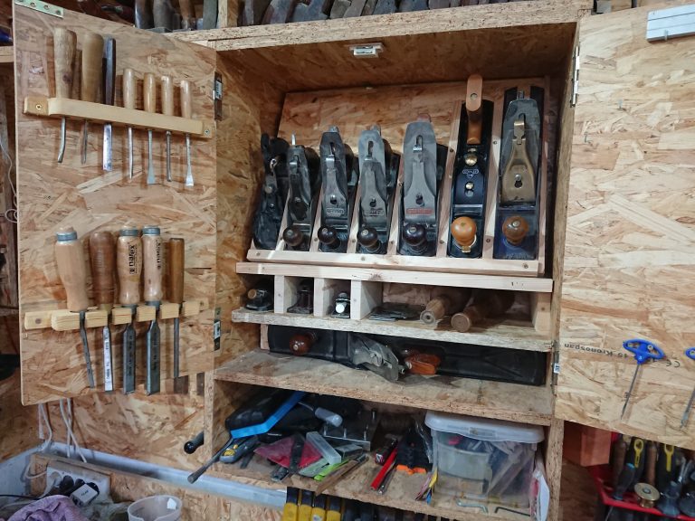 A cabinet with woodworking tools inside.